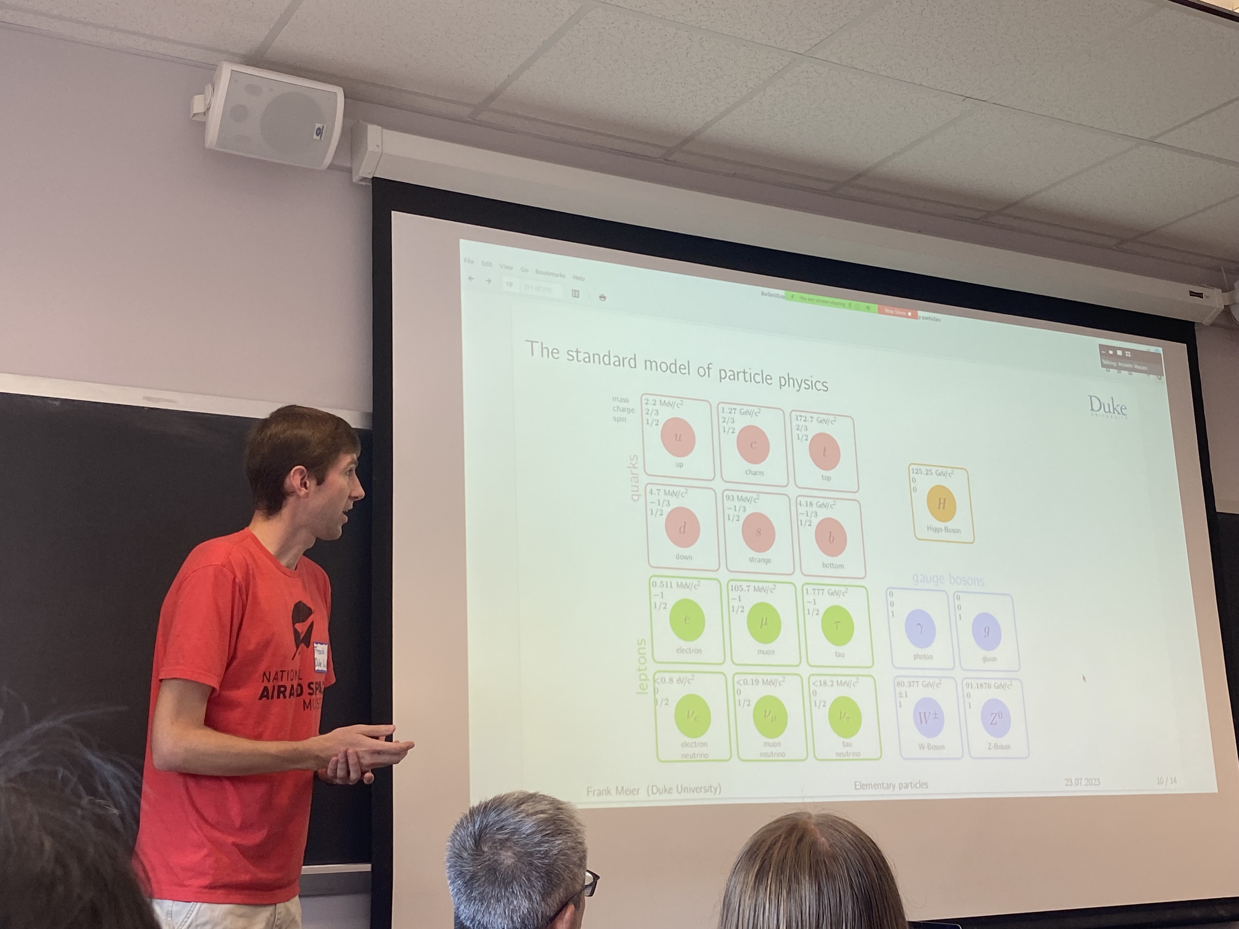 Belle II Postdoc giving an introductory session on particle physics